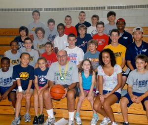 Campers sitting with basketball