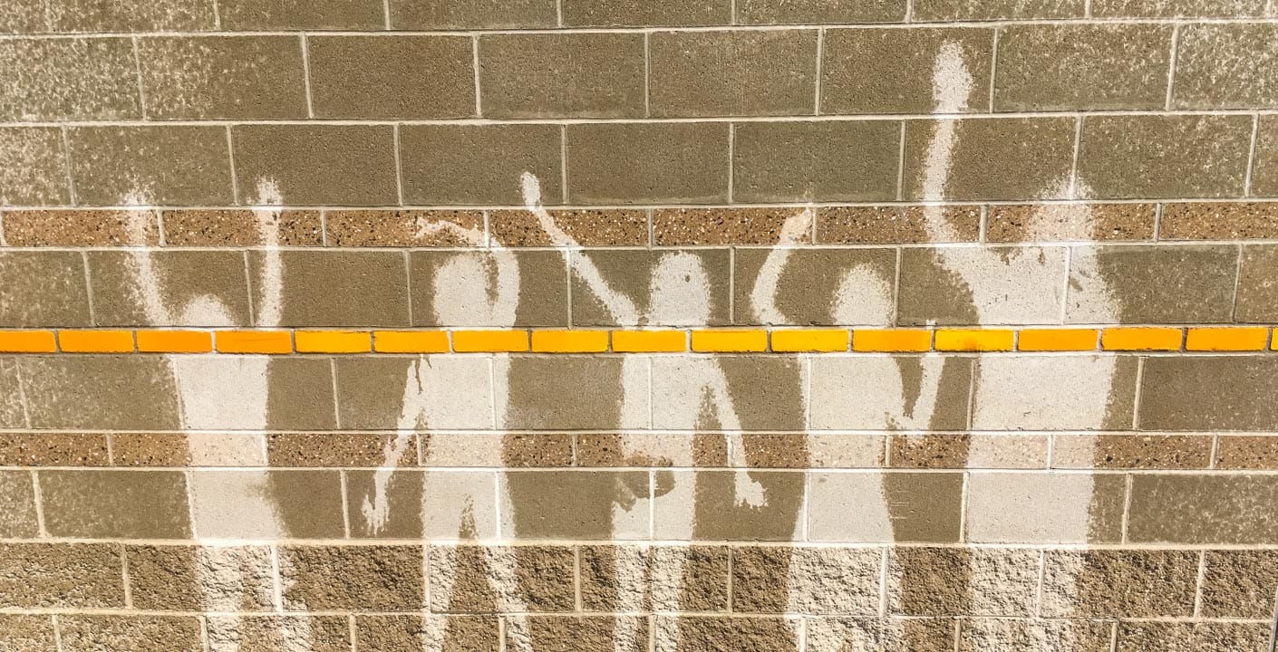 Outline of kids on wet wall by pool