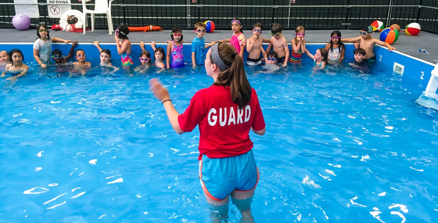 Lifeguard teaching campers how to swim