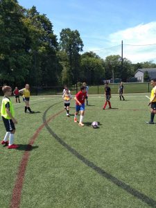 kids playing soccer at summer camp